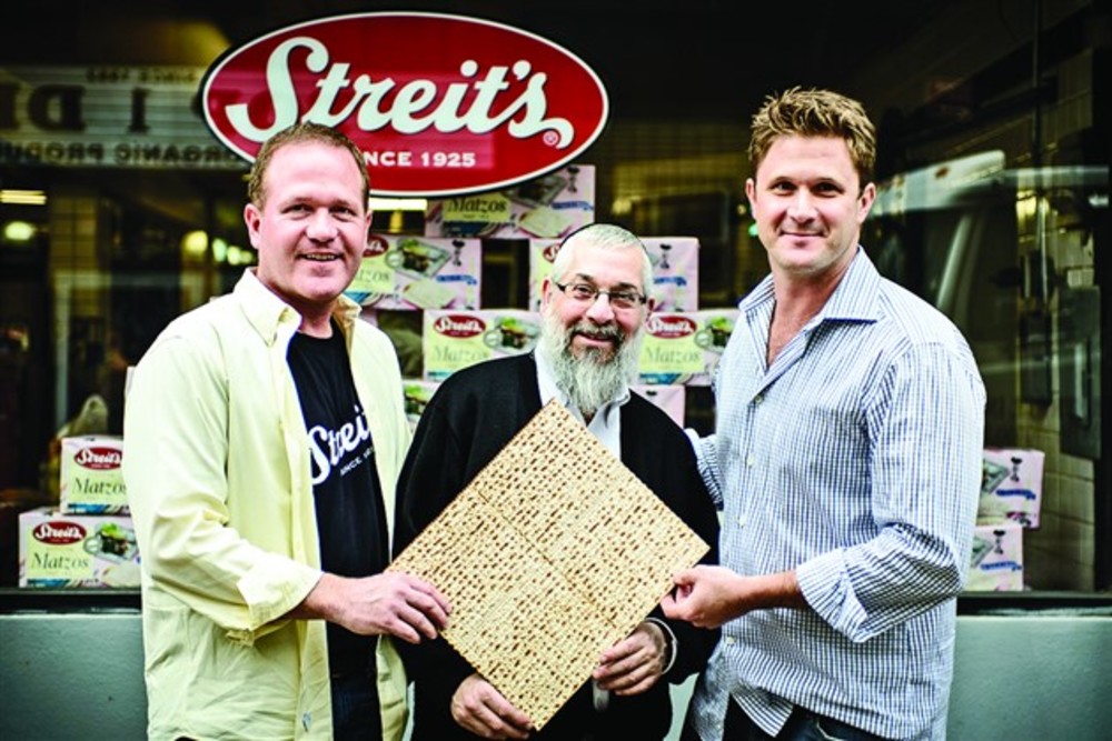 Cousins and Streit’s co-owners Aron Yagoda, left, and Aaron Gross, right, show off their matzah with Rabbi Mayer Kirschner, who makes sure everything is kosher. 